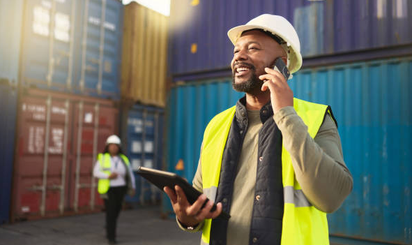 Supply operations manager in front of shipping containers